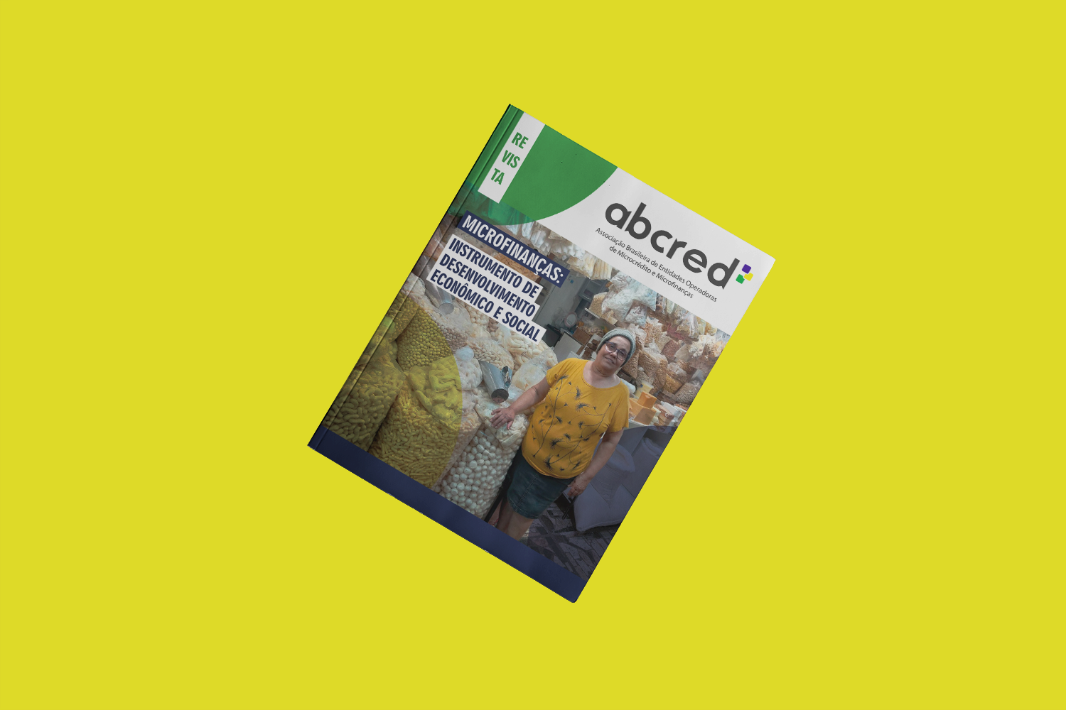 a imagem possui um fundo amarelo e ao meio em diagonal está a edição 2023 da revista ABCred